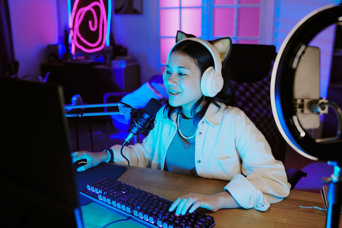 Player wearing headphones speaking into a microphone at a desk